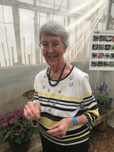 senior woman at butterfly garden