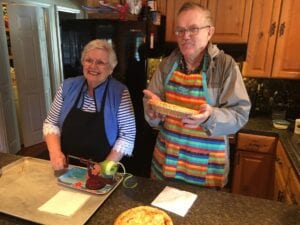 two seniors baking apple pie