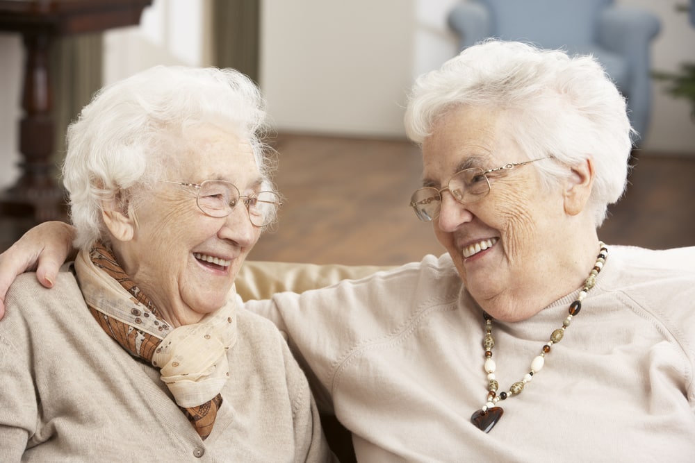 Two senior women smiling at each other