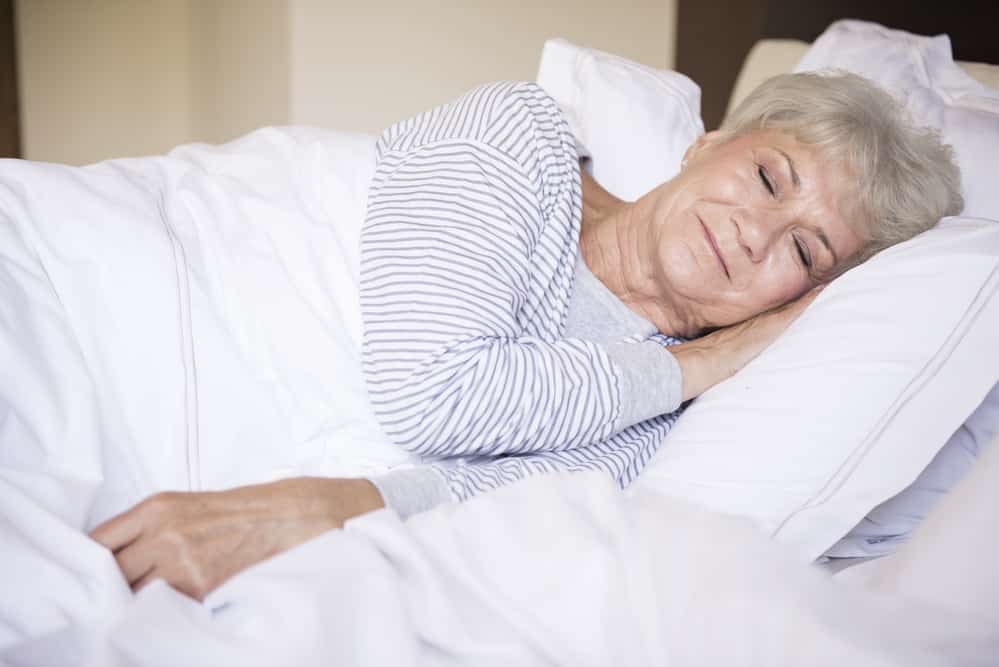 Senior woman sleeping peacefully on her side