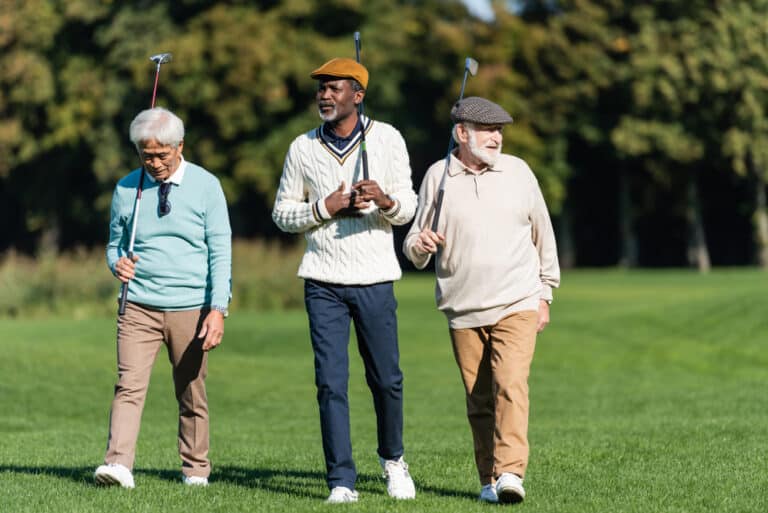 Three senior men golfing together