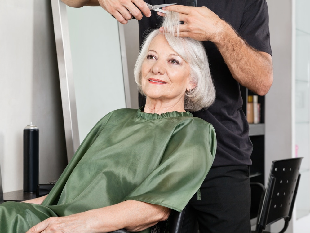 senior woman having her hair cut