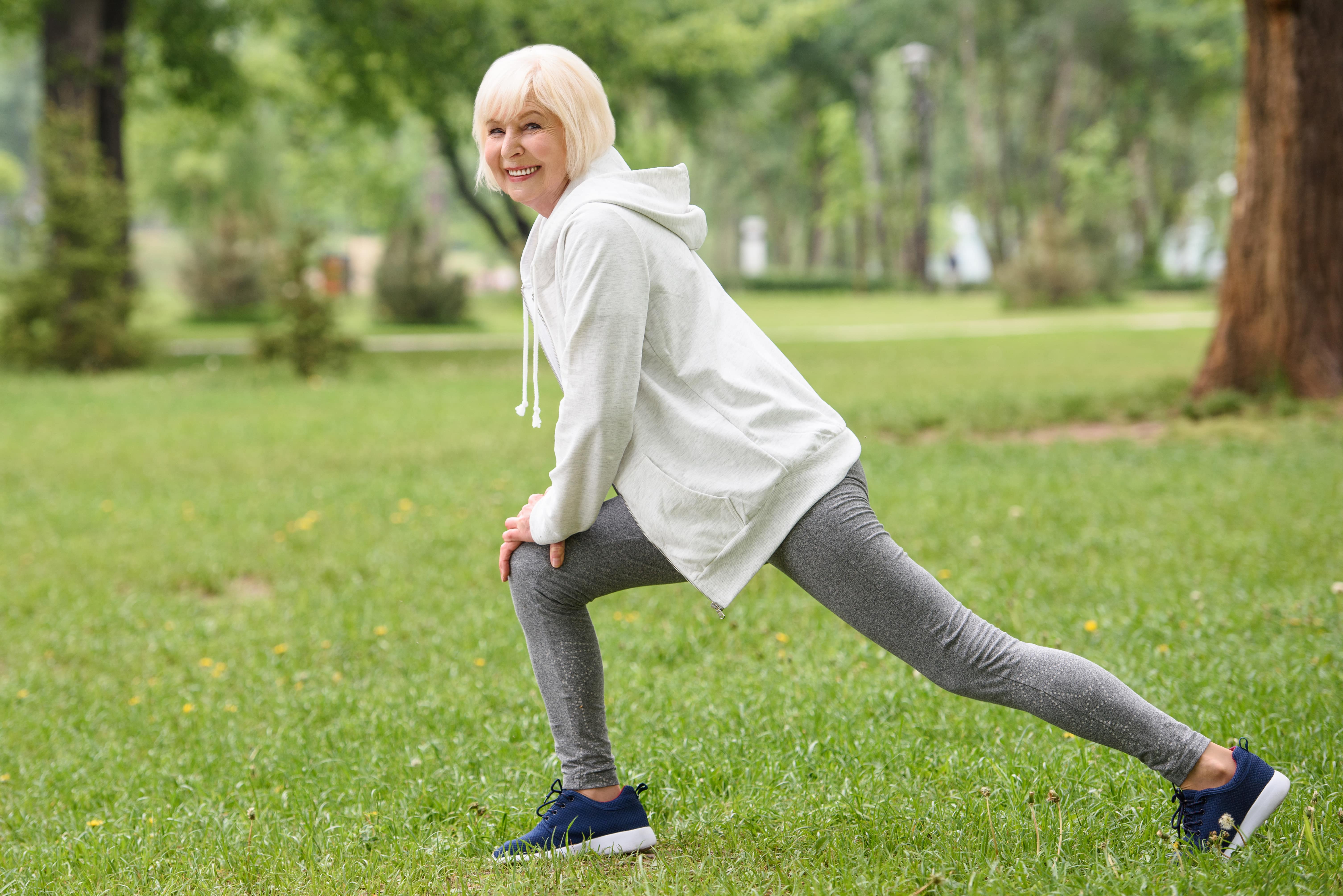 Senior woman stretching in the park